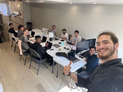 Tristan Gross with the TRIZAN team collaborating around a conference table