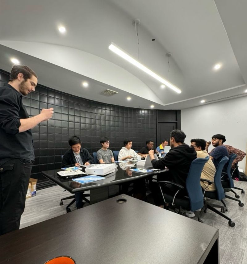 Tristan Gross leading a strategy meeting with the TRIZAN team around the table