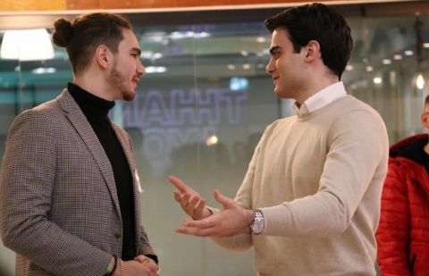 Tristan Gross in conversation with a colleague at a networking event