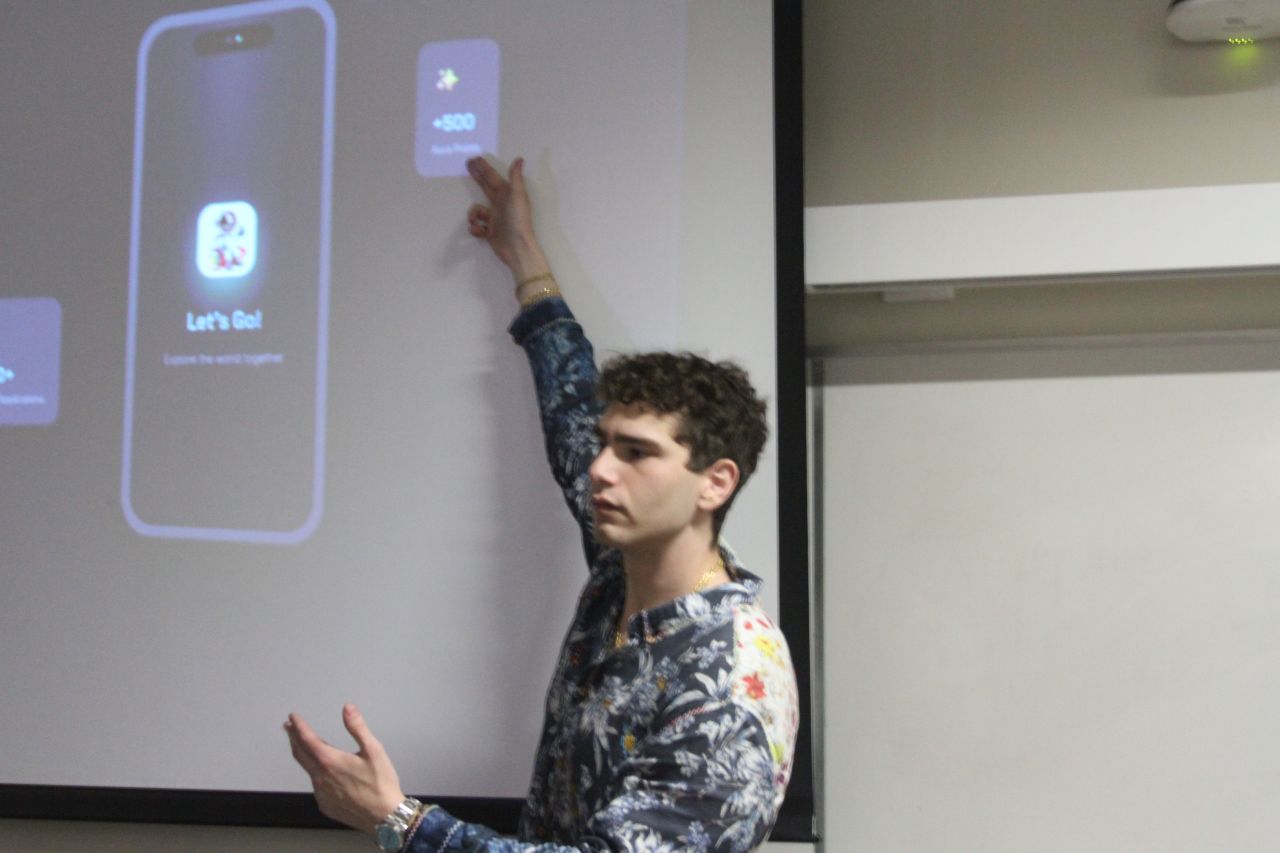 Tristan Gross presenting The Let's Go App on stage
