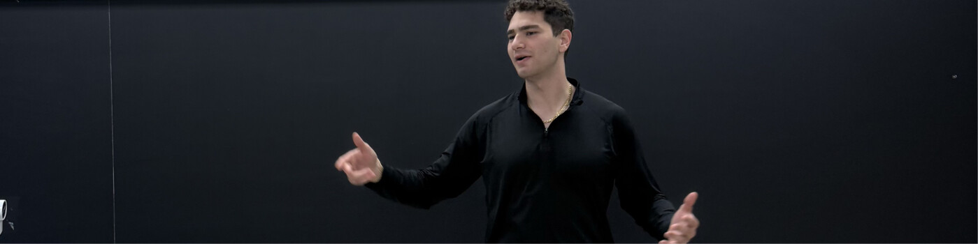 Tristan Gross speaking and gesturing on stage